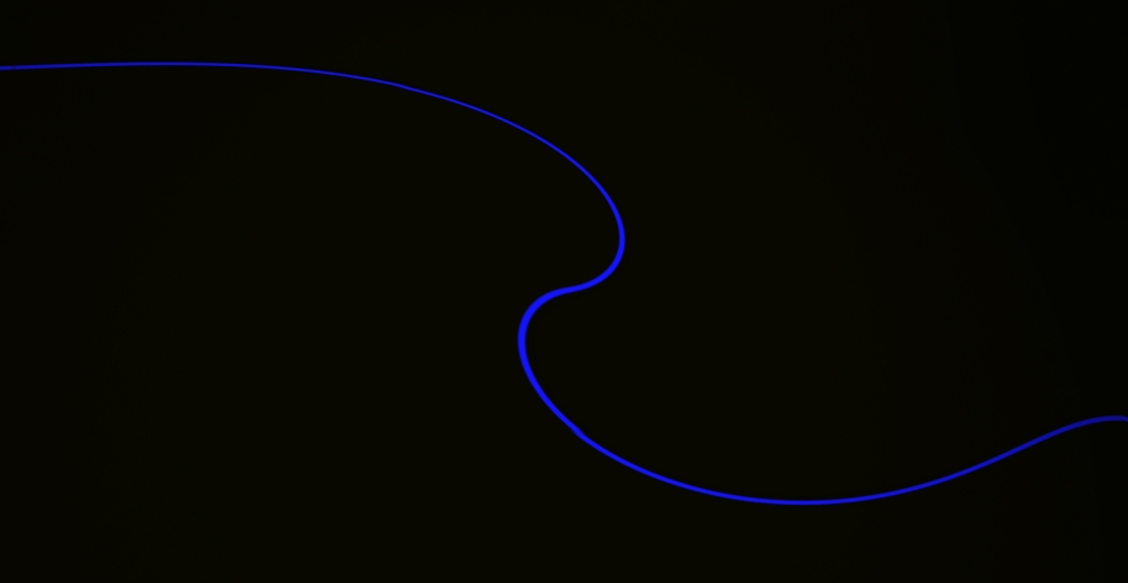 Photo is of a wavy thin blue line and a black background.